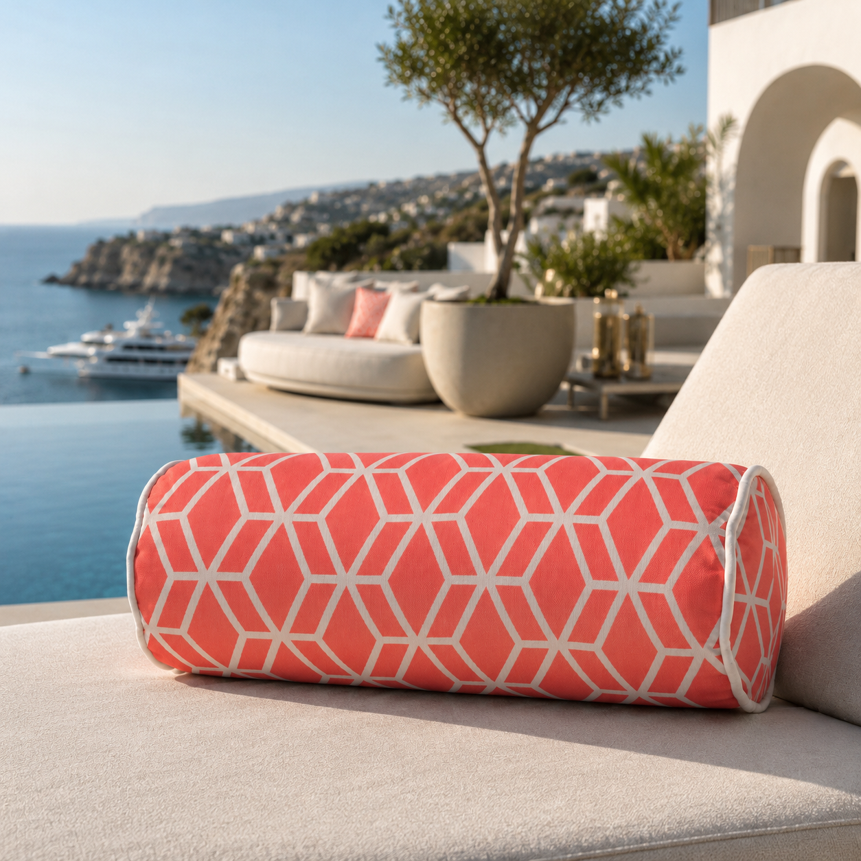 Korallenfarbene Designer-Nackenrolle Crystal Gold von chillisy® auf einer exklusiven Sonnenliege am Infinity-Pool mit Meerblick.