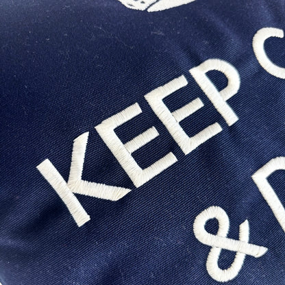 Decorative cushion “Keep Calm & Drink Champagne” – Navy blue with white embroidery