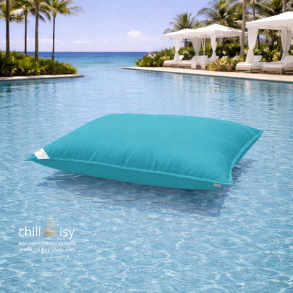 Premium Poolkissen Maxi 190x130 cm von chillisy in Türkis im Pool mit Meeranschluss treibend.